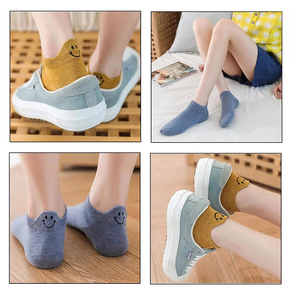 A collection of embroidered ankle socks in various colors and styles shown on feet.
