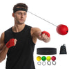 Un homme portant un bandeau noir tient une balle rouge et un bracelet orange, avec diverses balles colorées et un ruban noir 