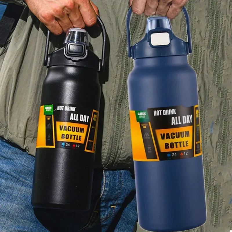 A dark gray vacuum bottle and a blue vacuum bottle are held by hands against a textured green fabric.