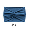 A folded navy blue fabric item, likely a boho wide turban headband.