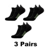 Three pairs of black performance compression sports socks displayed on a white background.
