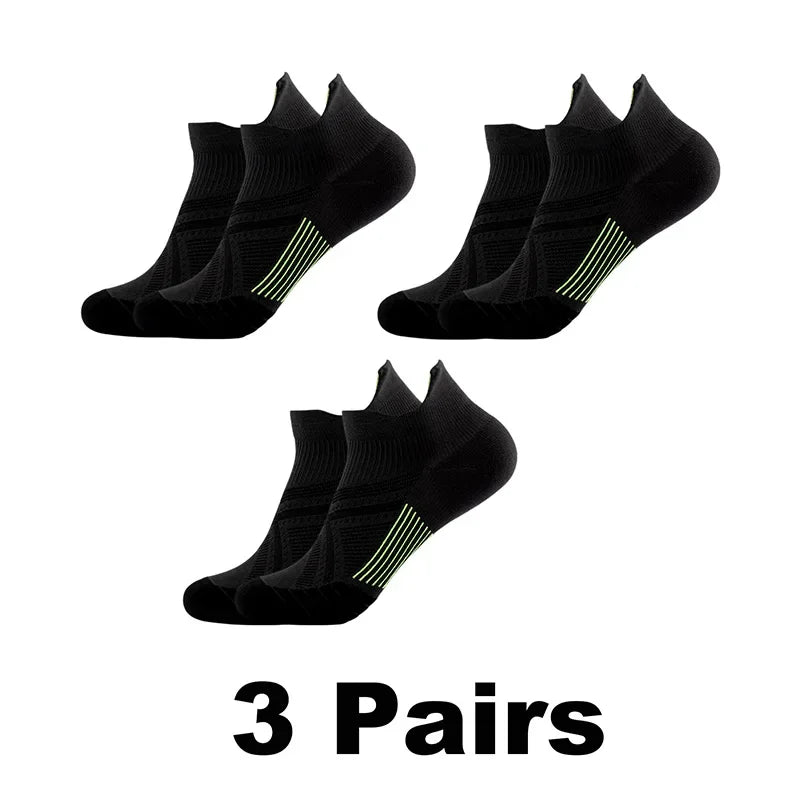 Three pairs of black performance compression sports socks displayed on a white background.
