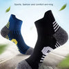 A pair of multi-functional professional sports socks in blue and black are shown on a surface.