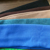 A stack of five blue elastic hairbands for fitness and yoga, showing various shades of blue.
