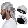 A man wearing a silky gray durag pirate headband with a black band and a tie detail.