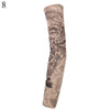 A close-up of a tan arm sleeve featuring an engraved skull design.