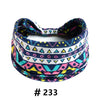 A colorful boho cotton turban headband featuring geometric patterns in blue, pink, and yellow.