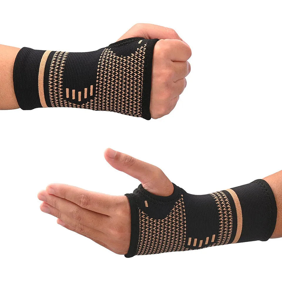 Black copper fiber wrist bracer worn on a hand for fitness and sport