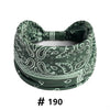 A dark green boho print cotton headband with an elastic band and decorative patterns.