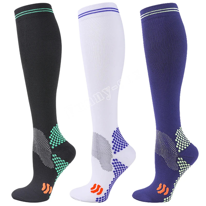 Three pairs of medical grade compression socks in black white and navy blue with patterned toes