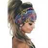 A woman wearing a colorful floral butterfly patterned headband in her hair.