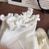 White knit crew socks featuring a ruffled cuff design.