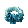 A light blue satin heatless curling rod headband with ruffled fabric.