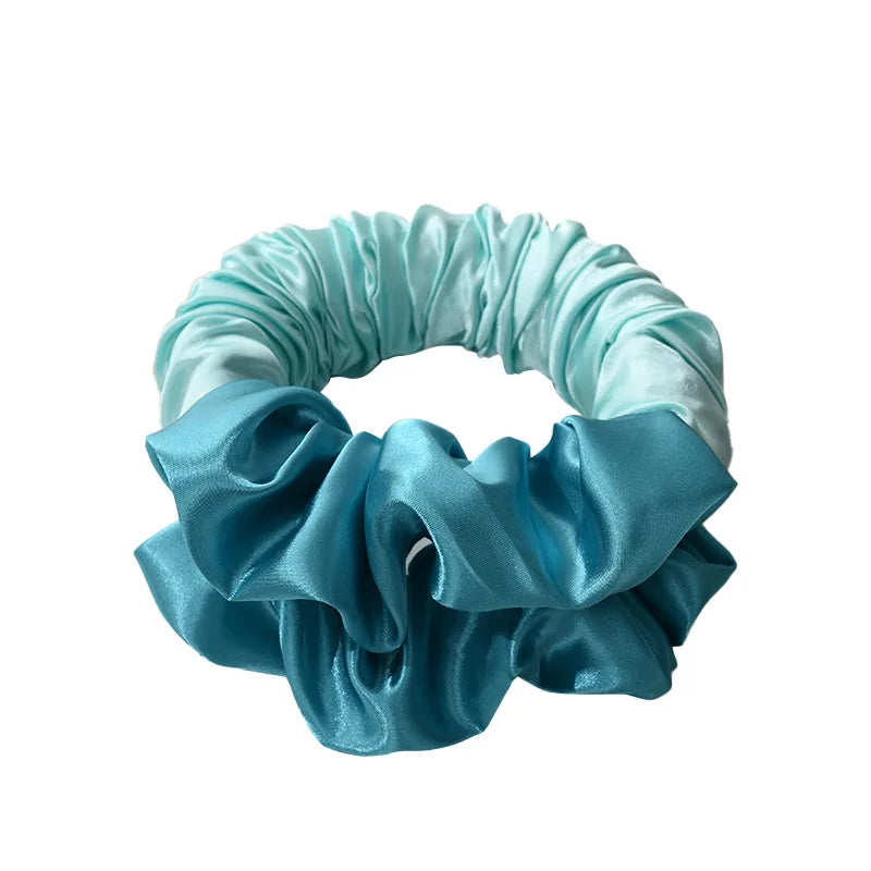 A light blue satin heatless curling rod headband with ruffled fabric.