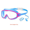 Pink and blue kids swim goggles with nose clips and earplugs shown against a white background
