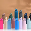 A collection of colorful stainless steel vacuum flask water bottles in various shades including pink, blue, green, and black.