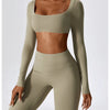 A model wears a seamless olive green long-sleeve top and matching leggings from a women's performance tracksuit set.