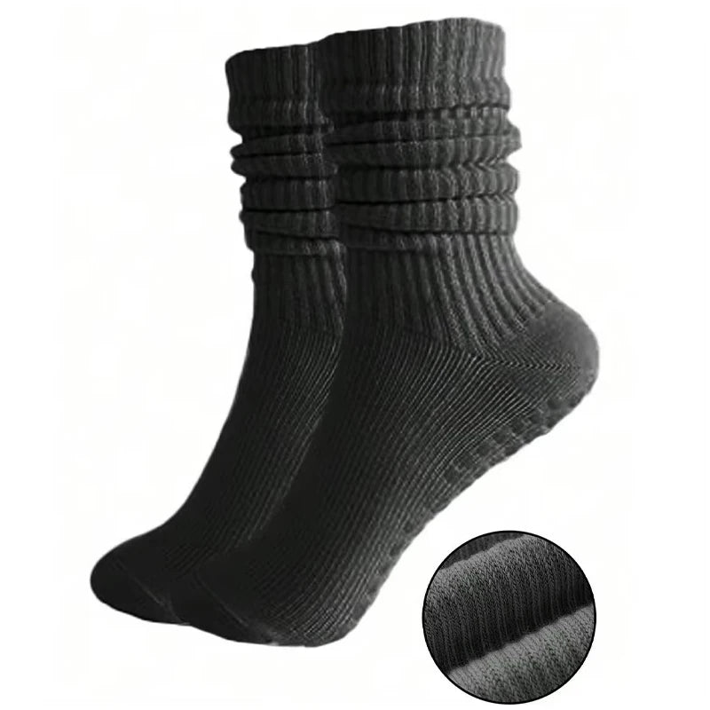 A set of three black silicone Pilates and yoga socks shown from the side.