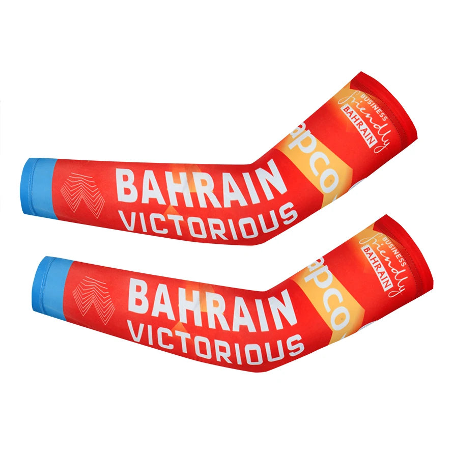 Red arm warmers with Bahrain victorious text and APCO branding for cycling.