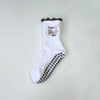 Chaussettes de yoga blanches avec broderie marron et motif antidérapant