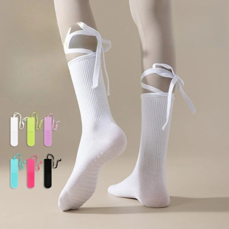 White silicone anti-slip yoga socks with adjustable ties and color options displayed on a foot.
