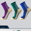 Three pairs of performance sports grip socks in purple, green, and blue with beige accents.