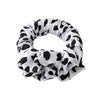 A black and white cow print heatless curling rod headband