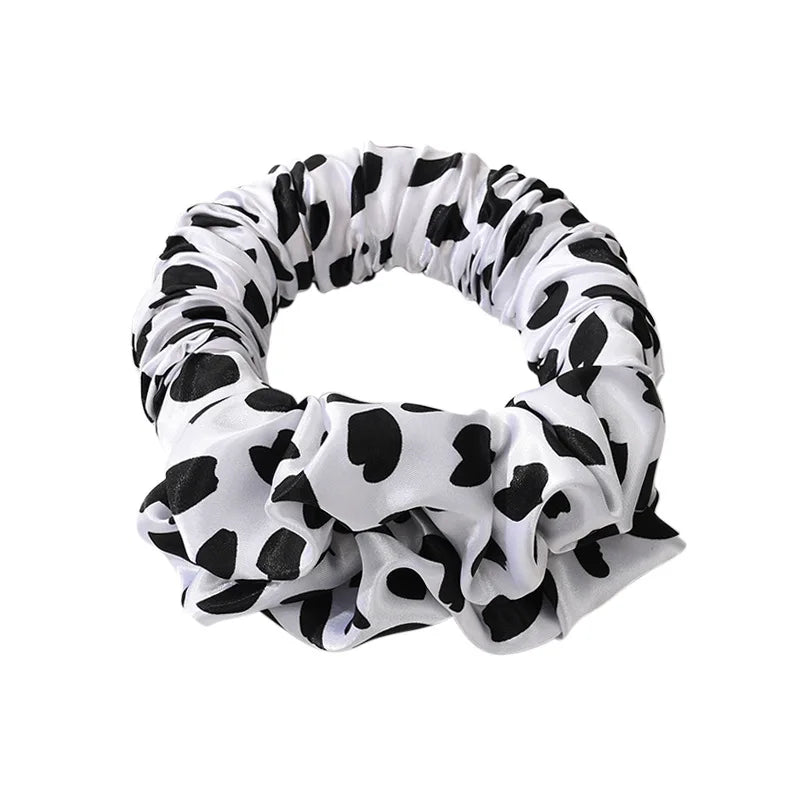 A black and white cow print heatless curling rod headband