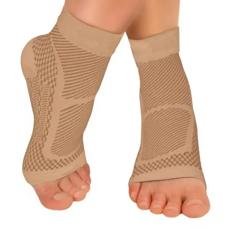 A close-up of beige therapeutic compression socks worn on a foot and ankle.