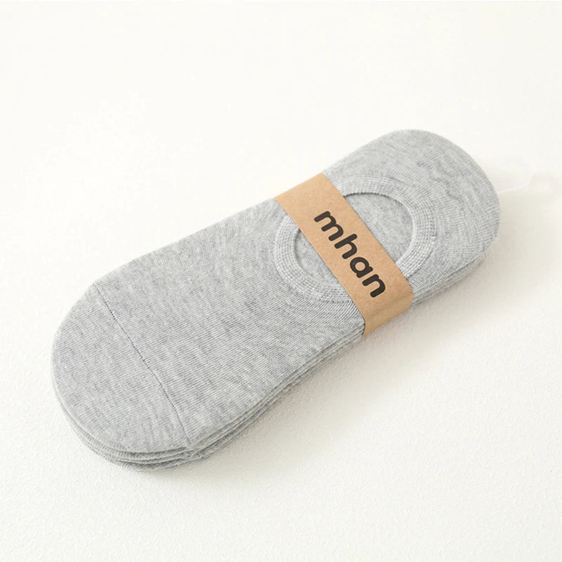 A gray ankle sock with a tan label featuring the brand name mhan