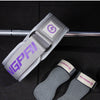 A gray fitness lifting belt is shown being held and laid out with accompanying grips.
