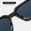 Close-up view of black retro square frame sunglasses with comfortable nose pads and dark blue lenses
