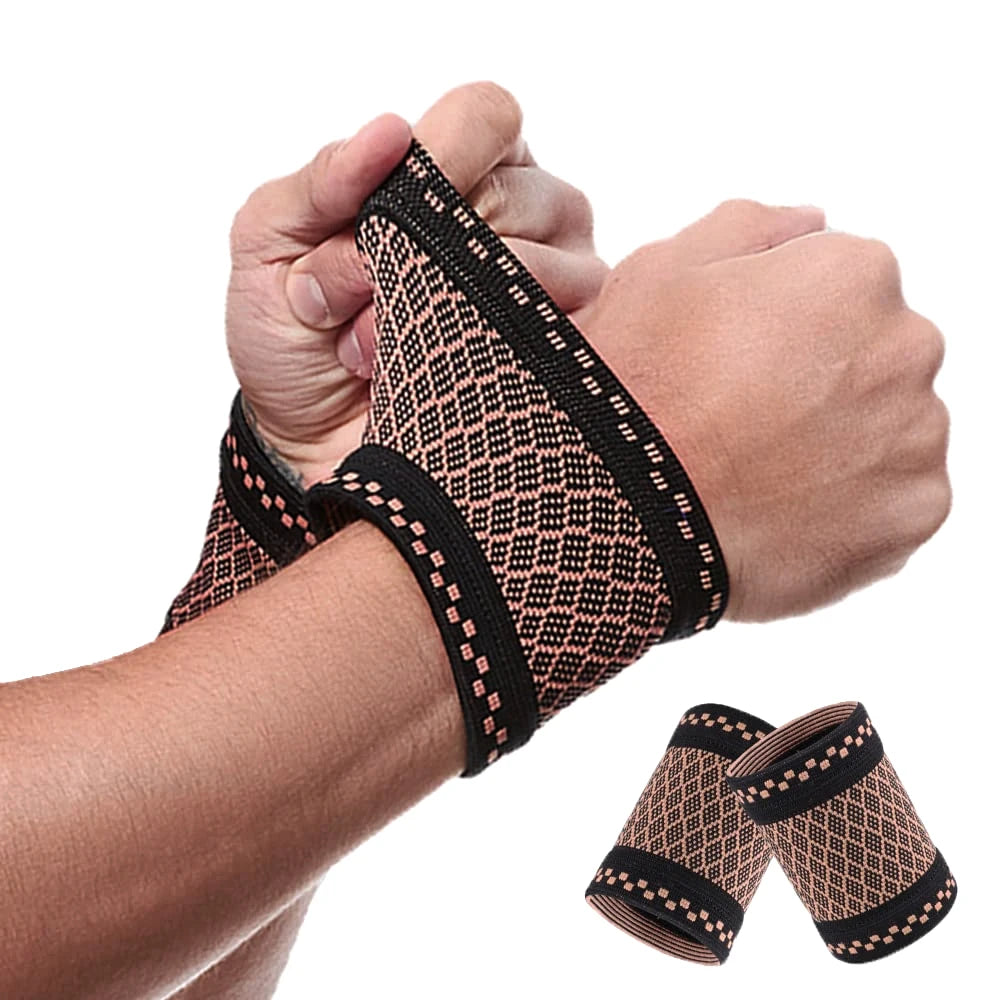 A hand is wearing a copper compression wrist sleeve for pain relief, showing the textured fabric and elastic band.