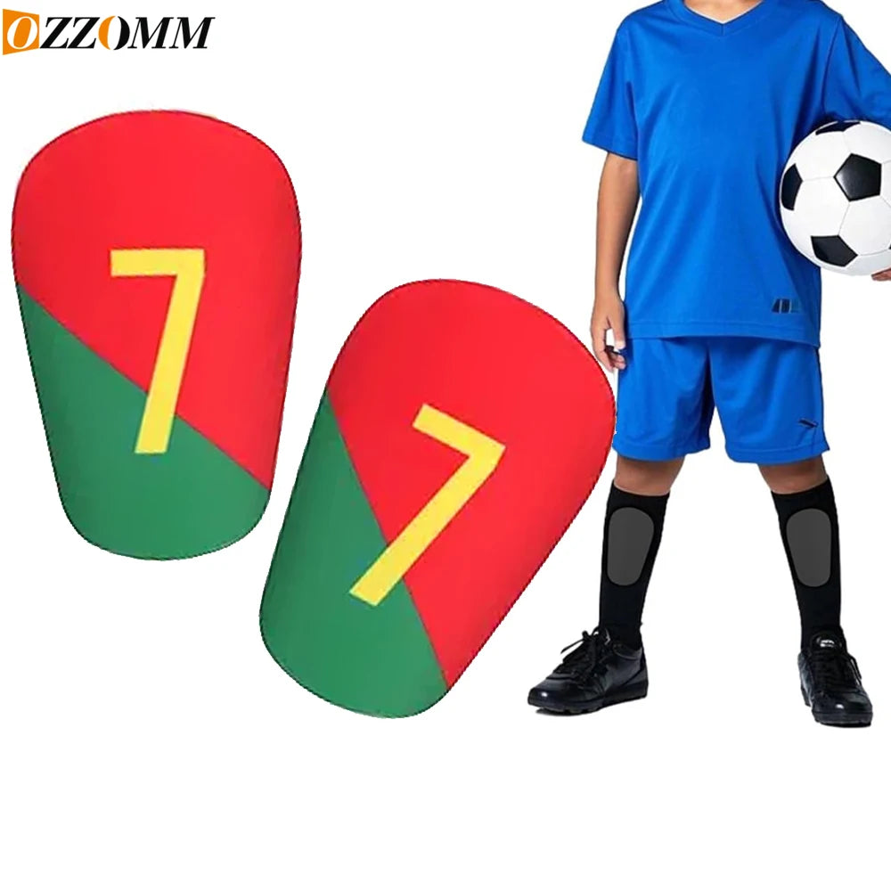 A blue-shirted boy wearing red and green soccer shin guards with the number 7 on them.
