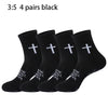 Four pairs of black prayer and cross grip sports socks are displayed.