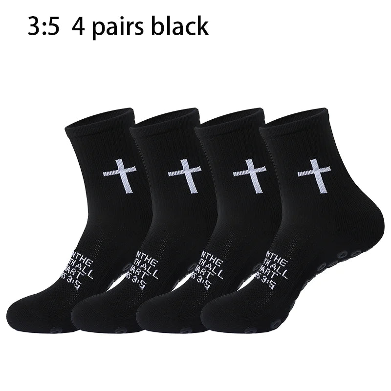 Four pairs of black prayer and cross grip sports socks are displayed.