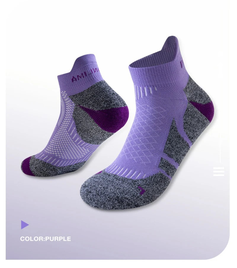 A pair of purple performance sports ankle socks shown flat lay.