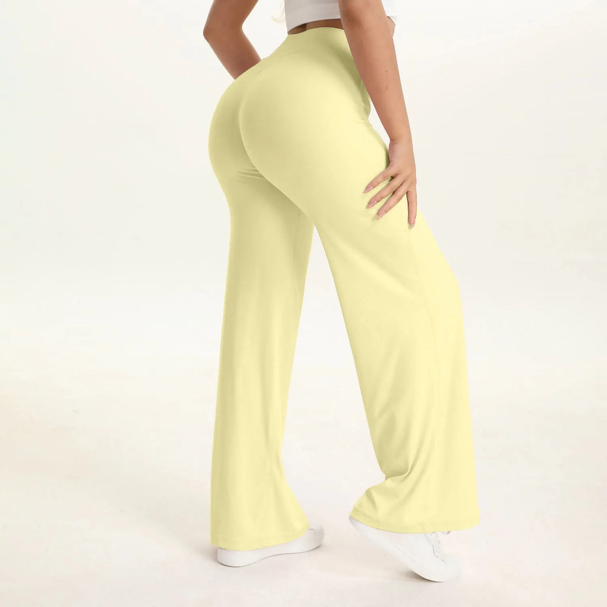 A person is modeling light yellow NCLAGEN SoftMotion Straight Leg Yoga Pants.