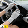 A hand wearing light gray UV protection gloves grips the steering wheel of a car.