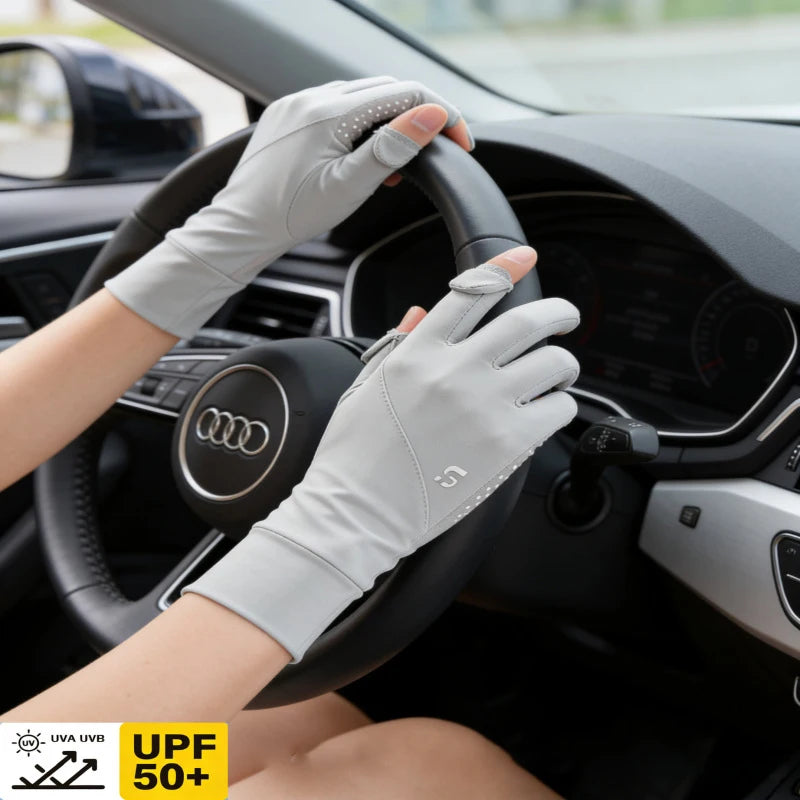 A hand wearing light gray UV protection gloves grips the steering wheel of a car.