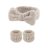 A set of light beige microfiber spa headband and wristband featuring a soft, fuzzy texture.