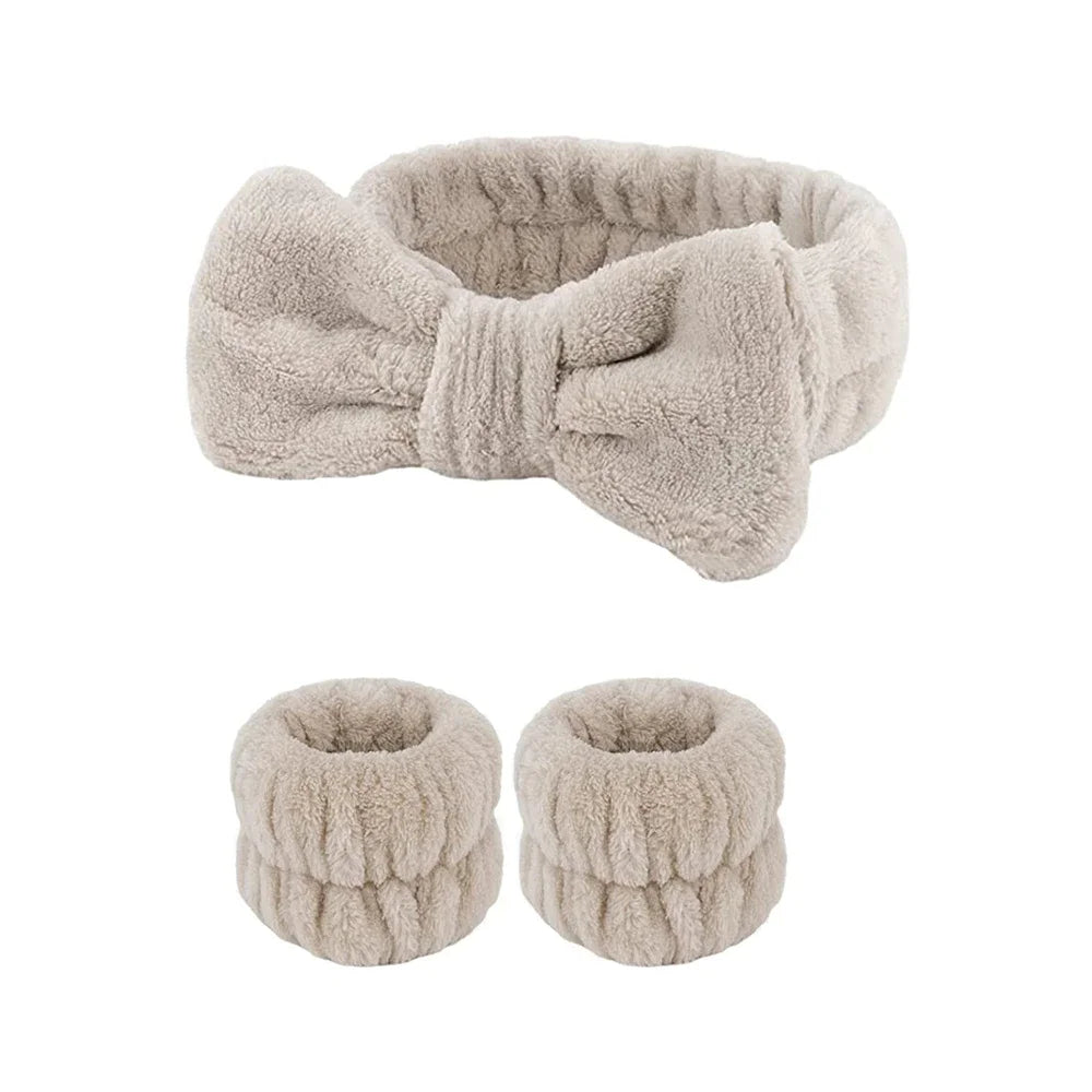 A set of light beige microfiber spa headband and wristband featuring a soft, fuzzy texture.