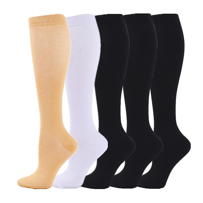 A row of medical grade compression socks in shades of beige, white, and black.