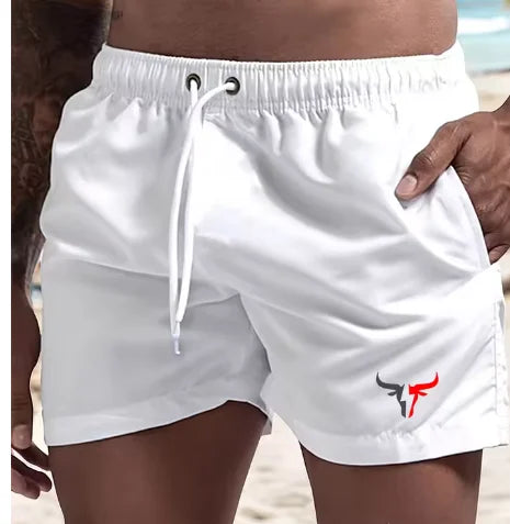 White quick-drying men's swim shorts being held by a hand