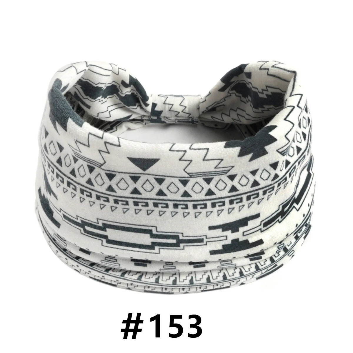 A white and black patterned boho cotton turban headband is shown flat.