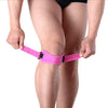 A person is wearing a pink adjustable patella tendon support brace on their knee.