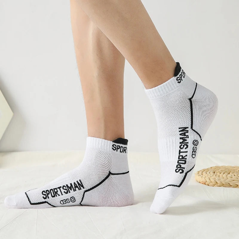 White athletic socks with black text featuring the word SPORTSMAN