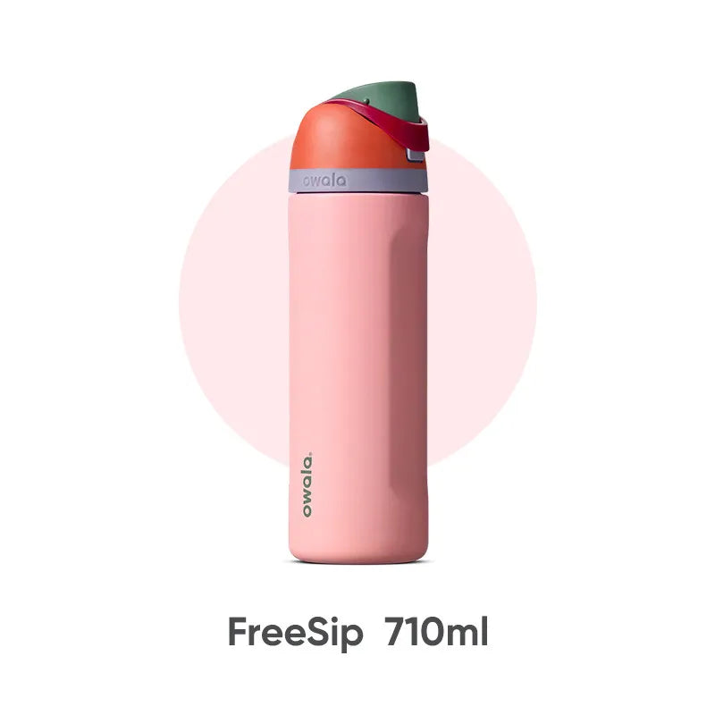 A pink Owala FreeSip 710ml tumbler with a green lid shown vertically.