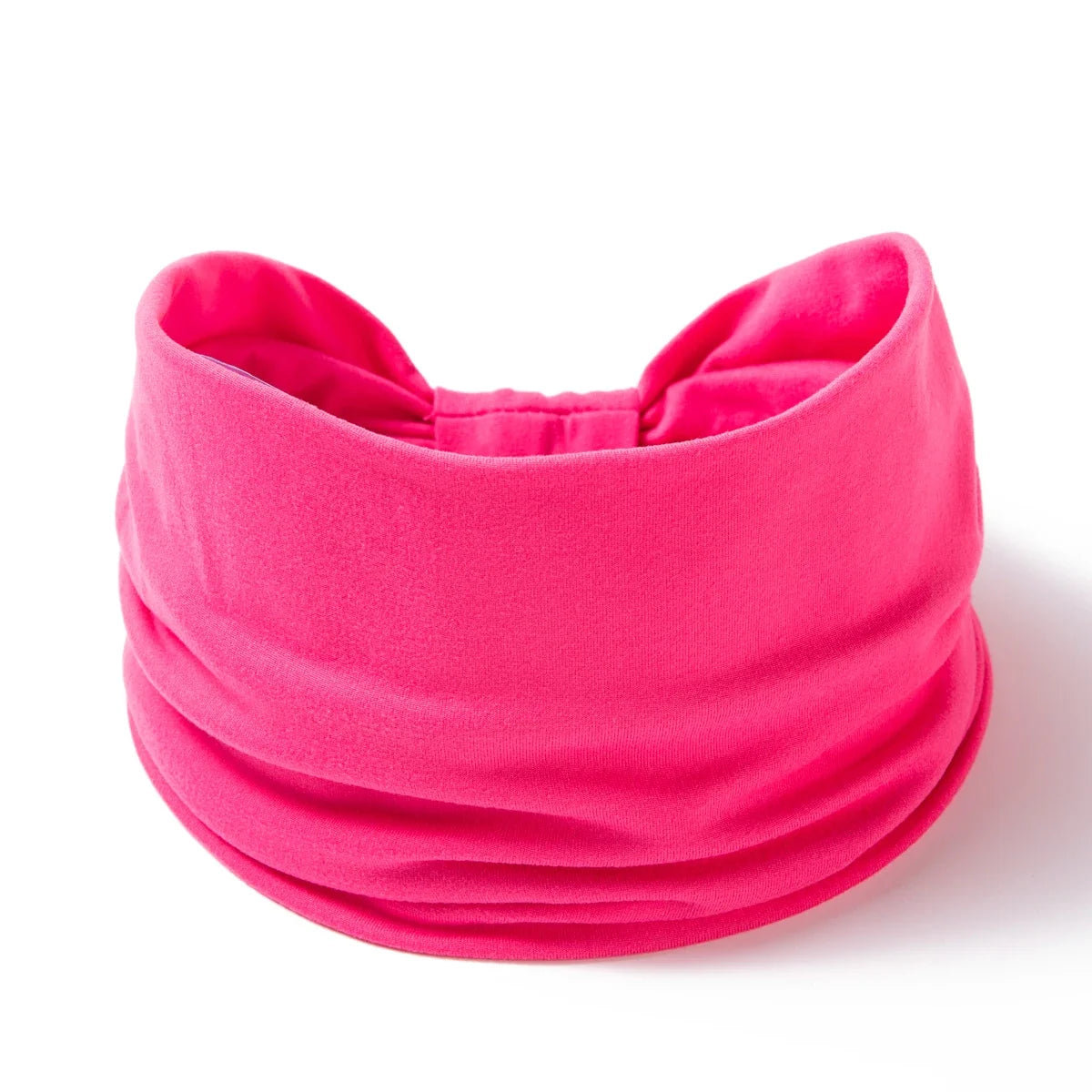A bright pink boho wide headband hair wrap for women shown flat.