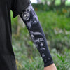 A close-up of a person wearing black ice silk tattoo sleeves on their arm.